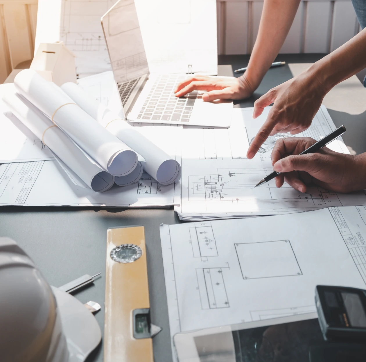 Team discussing architectural designs on desk