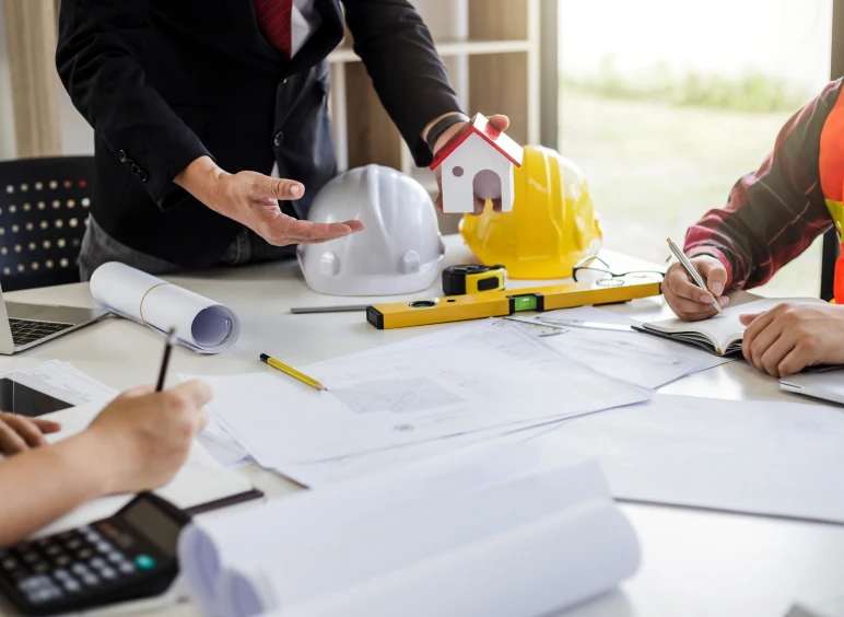 Construction meeting with blueprint and tools.
