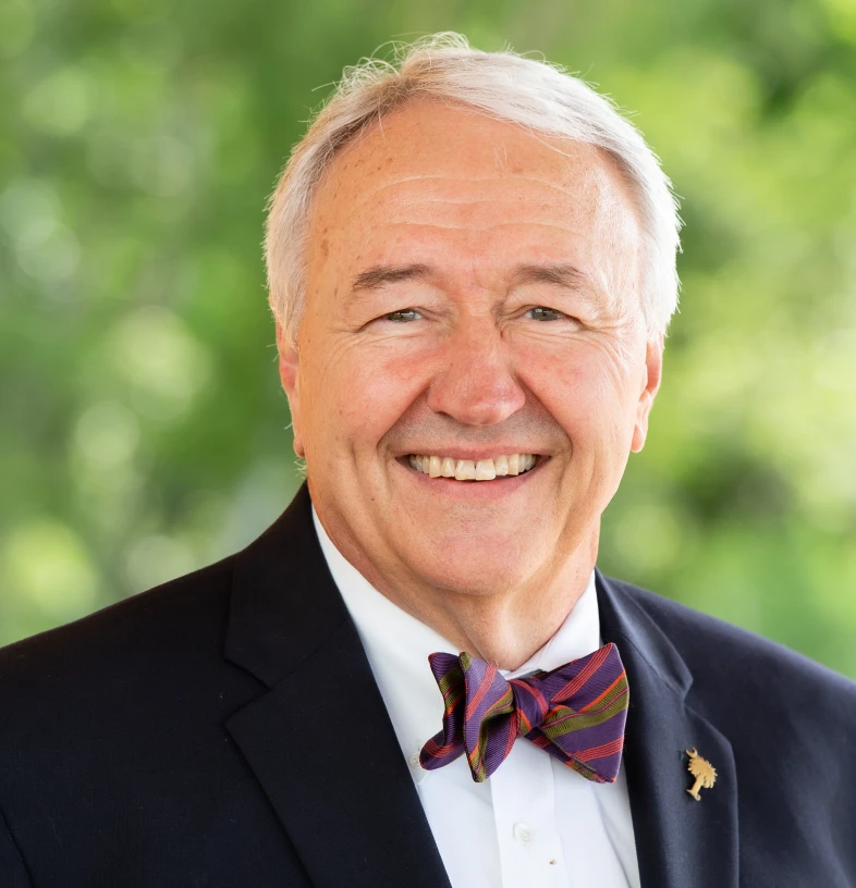 Man in formal attire outdoors.