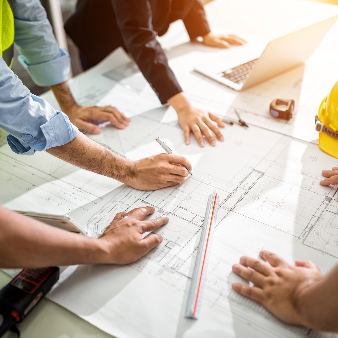 Engineers discussing building plans at table